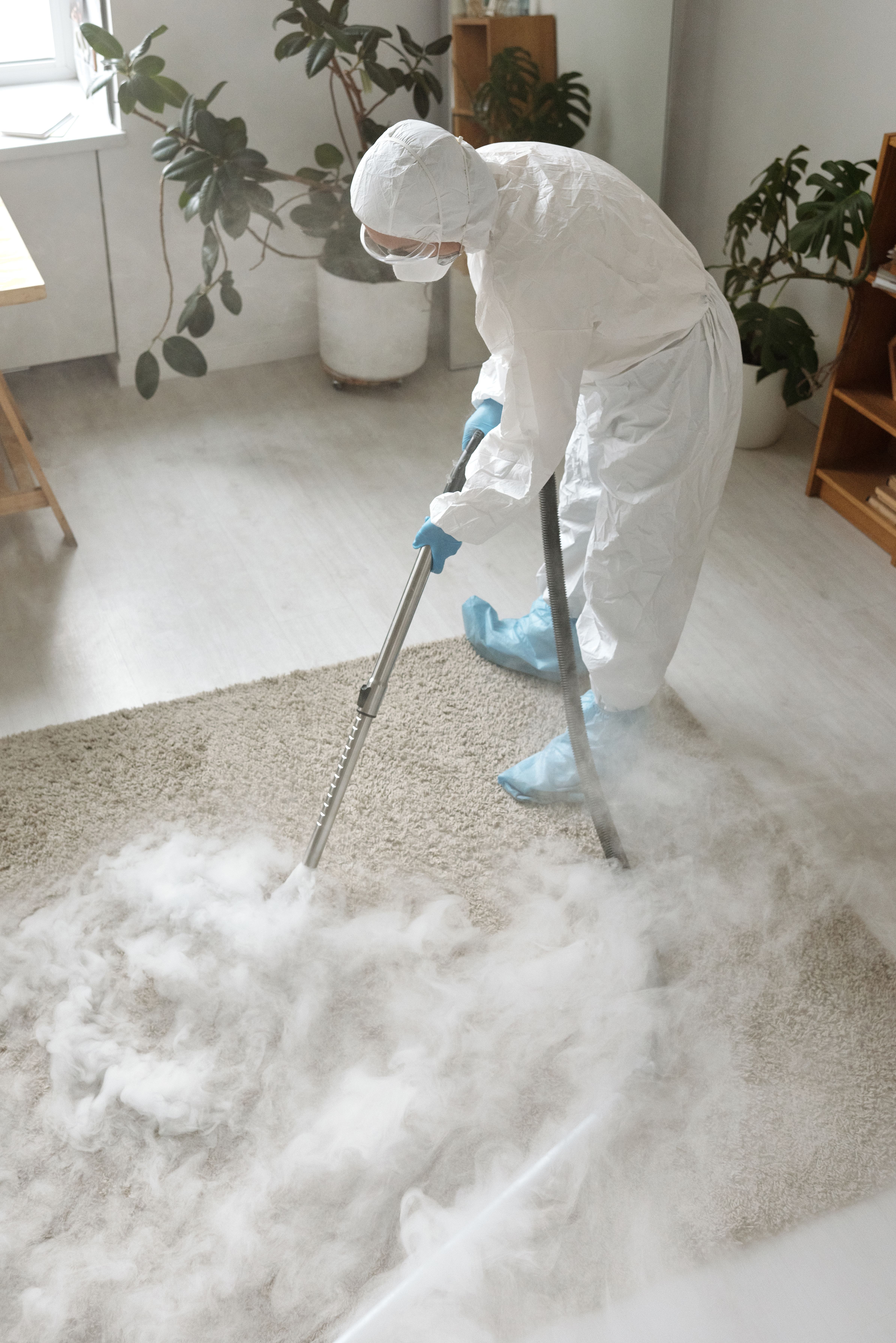 Carpet cleaning technician working an extraction wand through foamed pre-spray on light residential carpet in an Omaha, Nebraska home